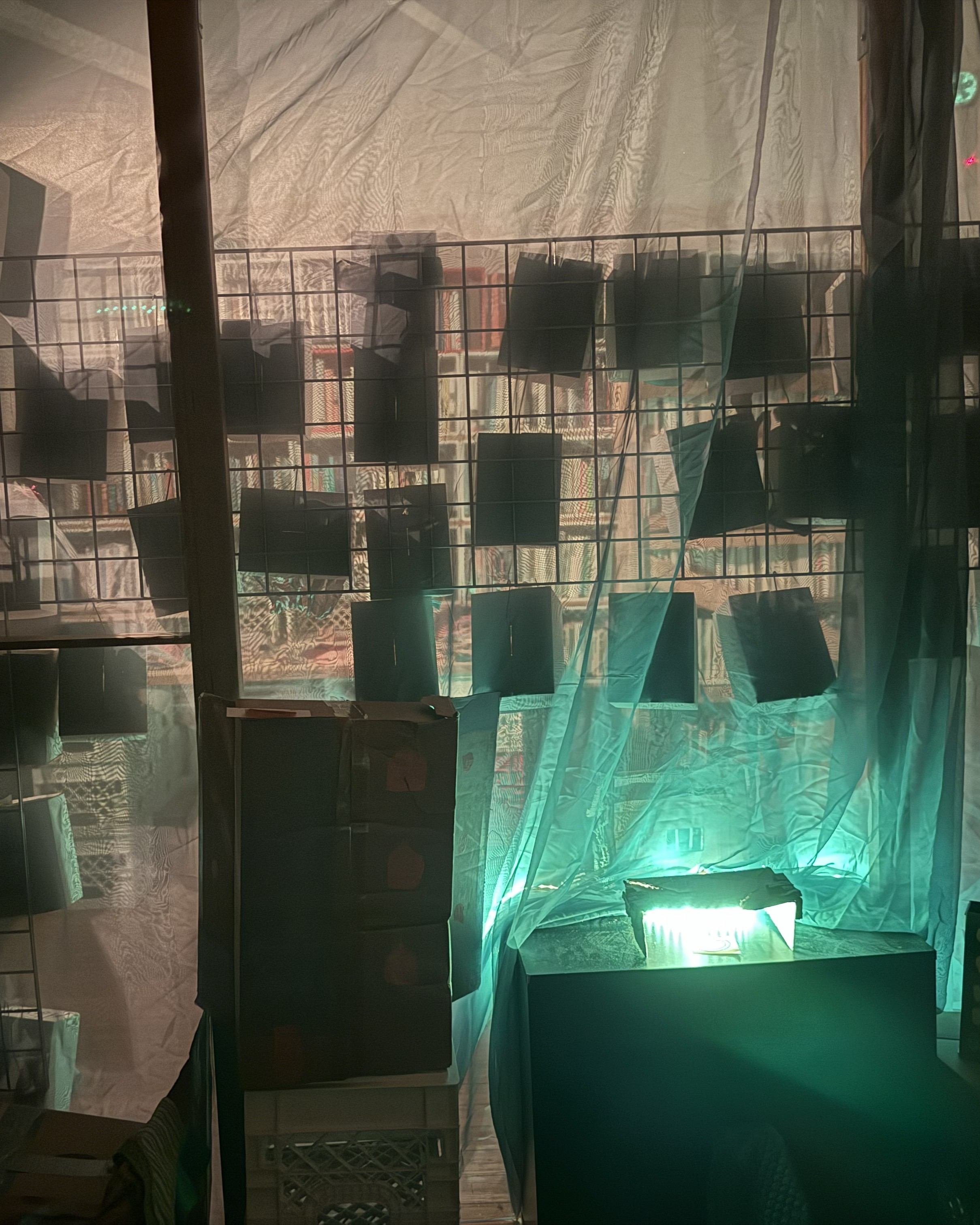 A room seen through a wall of backlit fabric.